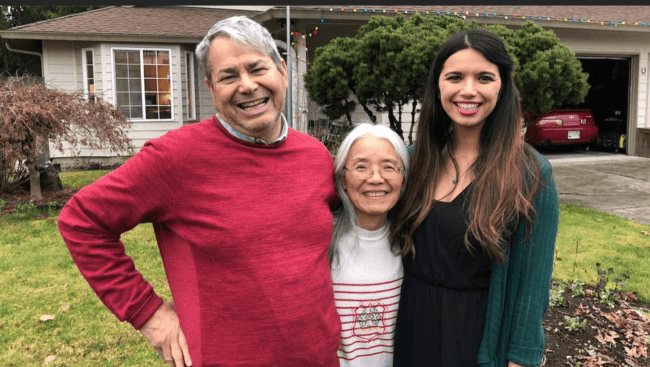 A photograph of Steve Sechrist with two other people, standing outside a house.